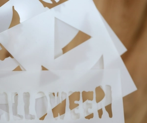 Detail of translucent PET Halloween stencils featuring cutout pumpkin and spooky text