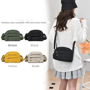 Detailed view of lightweight nylon crossbody bag featuring multi-layer zipper compartments