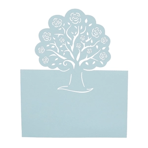Macro detail of laser cut tree design with rose patterns on light blue wedding place card
