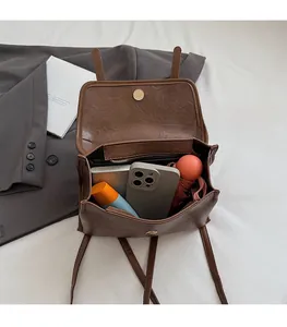 Interior view of vintage brown leather backpack showing large storage capacity for daily items