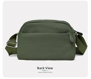 Close-up of the back zipper pocket and metallic buckles on army green crossbody bag
