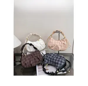 Detail shot of four checkered crossbody bags in cream, pink, brown, and black colors
