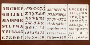 Macro view of four PET alphabet and number stencils for DIY painting and craft decoration