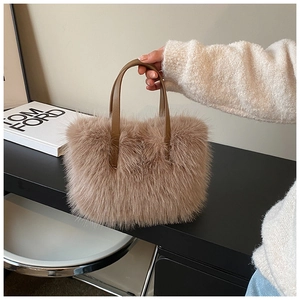 Macro detail of soft faux fur handbag with premium leather handles in light brown