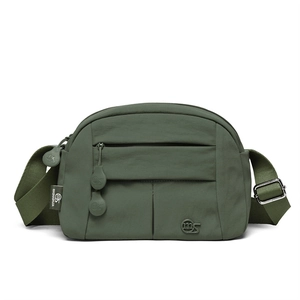 Detail view of the deep green nylon crossbody bag with MS logo and layered zippers