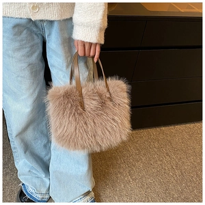 Detail showing plush faux fur texture and brown leather handle of the elegant tote bag