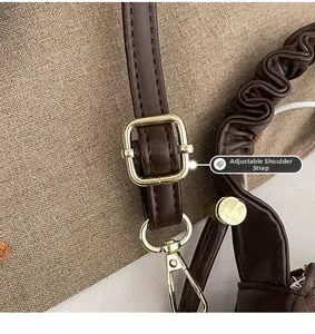 Detail of adjustable dark brown leather shoulder strap with golden metal buckle and hardware