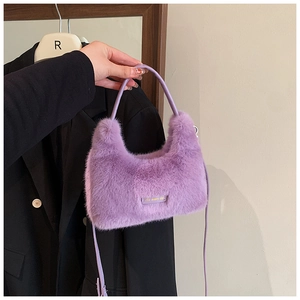 Detailed shot of purple faux fur bag with love every day tag and leather straps