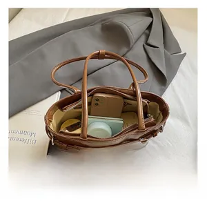 Detailed interior view of the brown PU leather tote bag showing spacious storage capacity