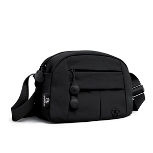 Close-up of black nylon crossbody bag featuring adjustable strap and side brand label