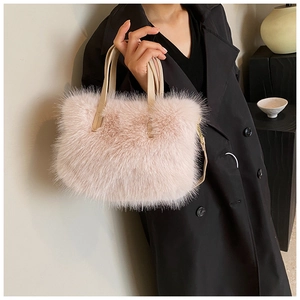 Detail of soft pink faux fur texture and beige leather straps on crossbody bag