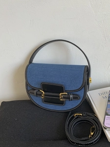 Retro denim saddle bag with black leather trim and contrast stitching details