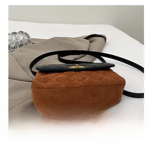 Detailed view of the wear-resistant brown suede bottom and quilting on the crossbody bag