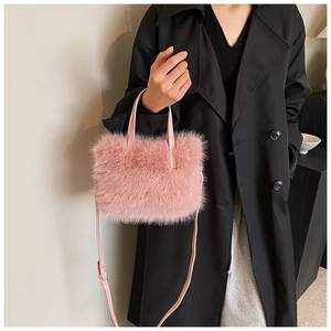 Pink faux fur handbag detail with thin leather straps and adjustable shoulder strap
