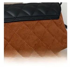 Detail showing the quilted black leather and brown suede textures on the flap square bag