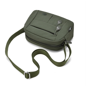 Detail view of olive green nylon crossbody bag showing multiple zippers and shoulder strap