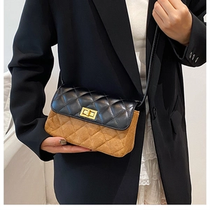 Detail of color-block quilted shoulder bag with gold twist lock on black blazer outfit