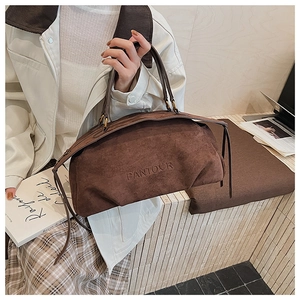 Detail of vintage brown suede handbag showing the embossed PANTOUR logo and thick texture