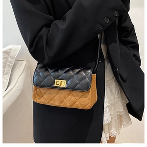 Close-up of diamond quilted crossbody bag with gold metal turn-lock and contrast texture