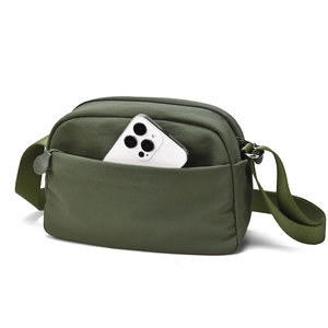 Detail view of military green crossbody bag with zipper compartments and nylon texture