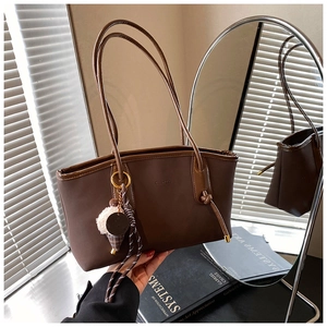 Detail of vintage brown tote bag with Chan'seb logo and cute plush ice cream pendant