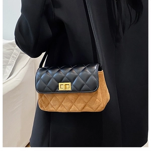 Detailed view of bicolor crossbody bag with quilted stitching and gold rectangular lock