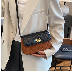 Detail of vintage square bag with black quilted flap and brown suede crossbody strap