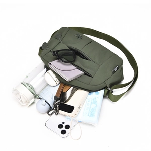 Spacious interior of olive green crossbody bag showing umbrella, phone, and wallet storage