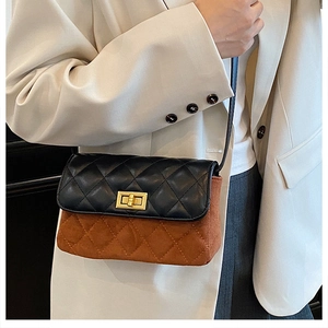 Detail of quilted leather crossbody bag with golden rectangular turn-lock and suede panels