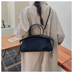 Detail showing the PANTOOR black matte suede texture and adjustable leather strap on the bag