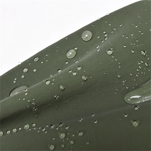Close-up of water-resistant fabric with droplets on casual olive green crossbody bag