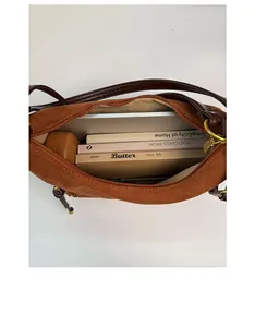 Top view of brown suede shoulder bag showing large capacity for books and daily items