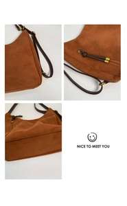 Detail of vintage caramel suede bag featuring leather tassels and gold-tone hardware