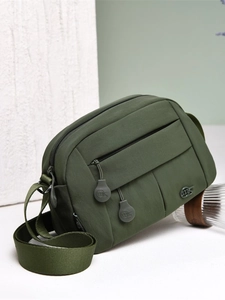 Olive green nylon crossbody bag with multiple zip pockets and wide strap for daily commute