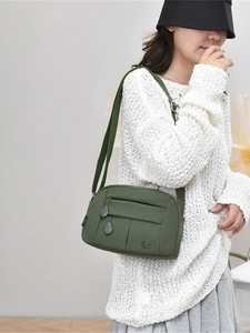 Versatile army green nylon crossbody bag with multi-zipper pockets and adjustable strap