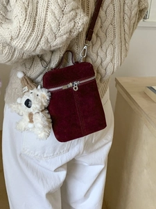 Burgundy matte vintage bucket bag with plush dog charm and adjustable crossbody strap