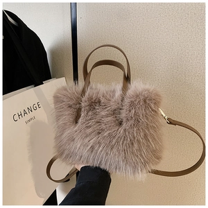 Detailed close-up of soft faux fur texture and brown leather handle on a fluffy tote bag
