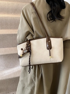 Retro large capacity shoulder tote bag in beige and brown leather shown on model