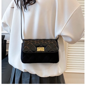 Detailed back view of a black quilted crossbody bag with a mix of leather and suede