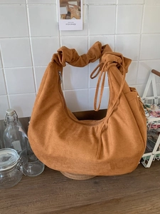 Caramel brown suede hobo bag with scrunchie handle and drawstring crescent shape