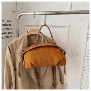 Detail of brown suede crescent bag with PANTOOR embossed logo and leather straps