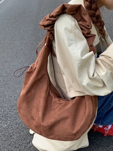 Brown faux suede hobo bag featuring a pleated shoulder strap and large capacity