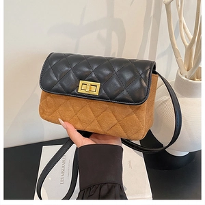 Detail of vintage square bag showing contrast leather texture and gold metal turn-lock