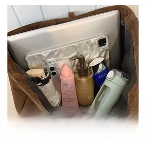 Internal view of large capacity tote bag showing laptop and daily essentials storage