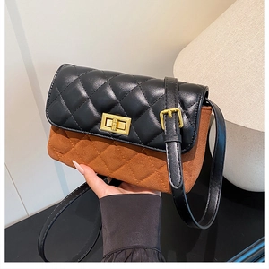 Detail of vintage rhombic quilted shoulder bag with gold twist lock and bicolor finish