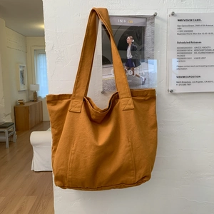 Detail of reinforced stitching and durable canvas texture on a large tote bag