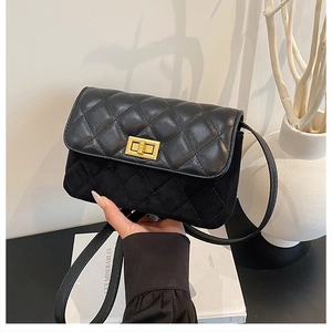 Detail of black quilted leather shoulder bag featuring a gold twist lock and elegant stitching