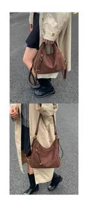 Detail of dark brown matte hobo bag with vertical zip pocket and long straps