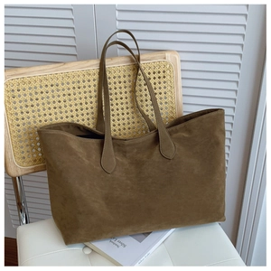 Detail of minimalist dark brown matte suede tote bag with long double shoulder straps