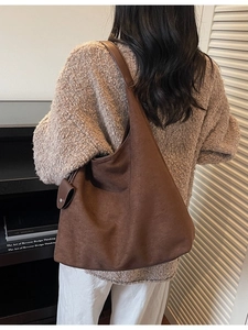 Deep brown oversized suede hobo bag shown on model with retro autumn minimalist style